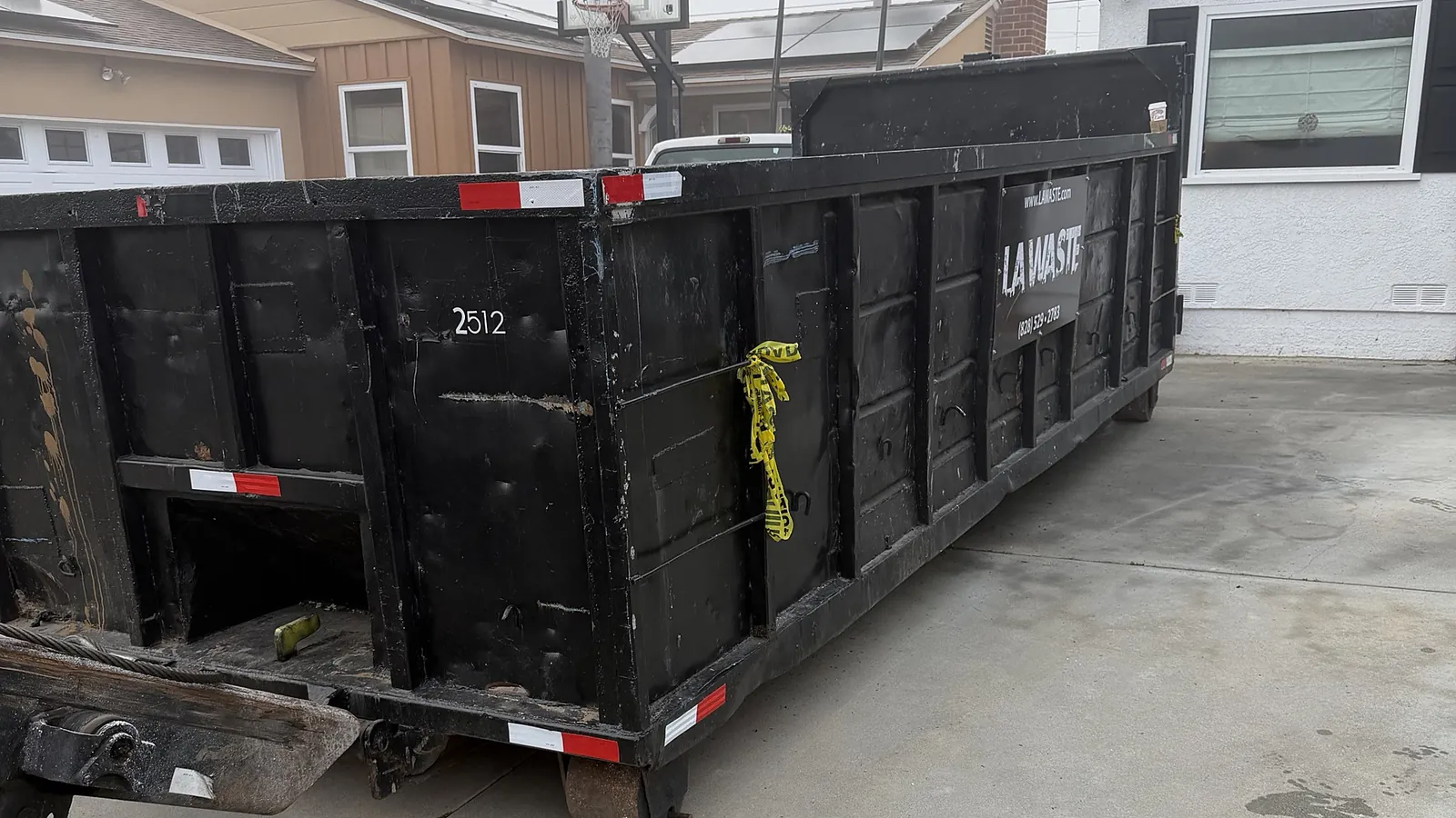 LA Waste 25 yard dumpster placed on a residential driveway