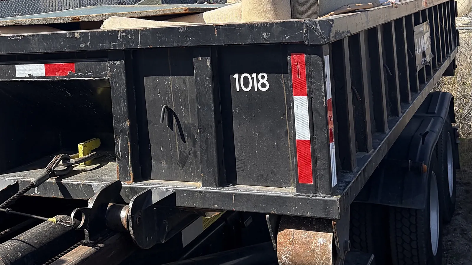 LA Waste 10 yard low boy dumpster loaded on a roll off truck