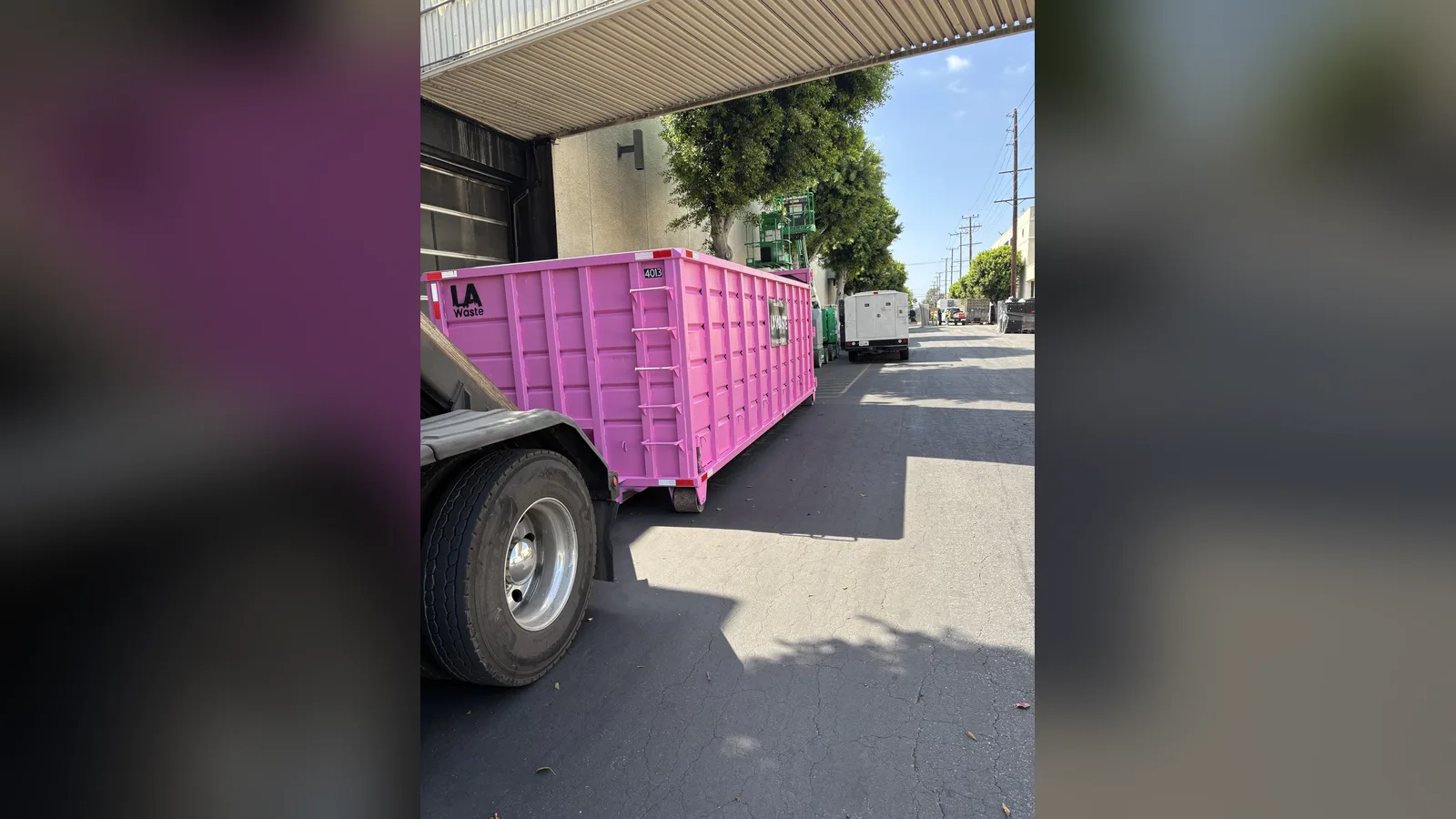 Pink LA Waste 40 yard dumpster delivered to a commercial loading dock
