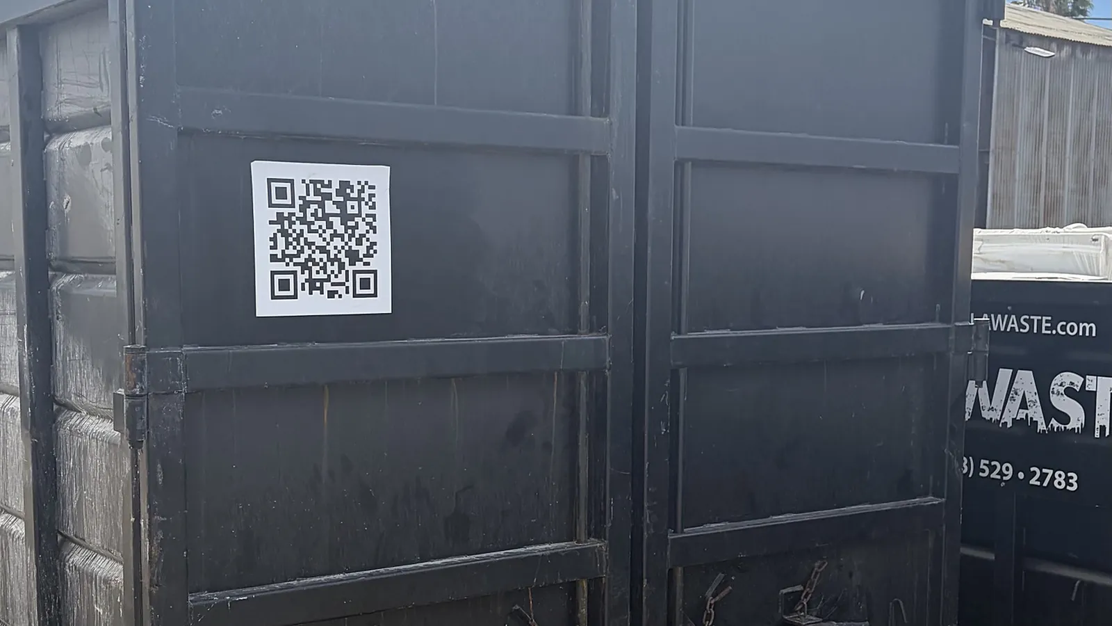 LA Waste roll off dumpster with rear doors and QR code at the yard