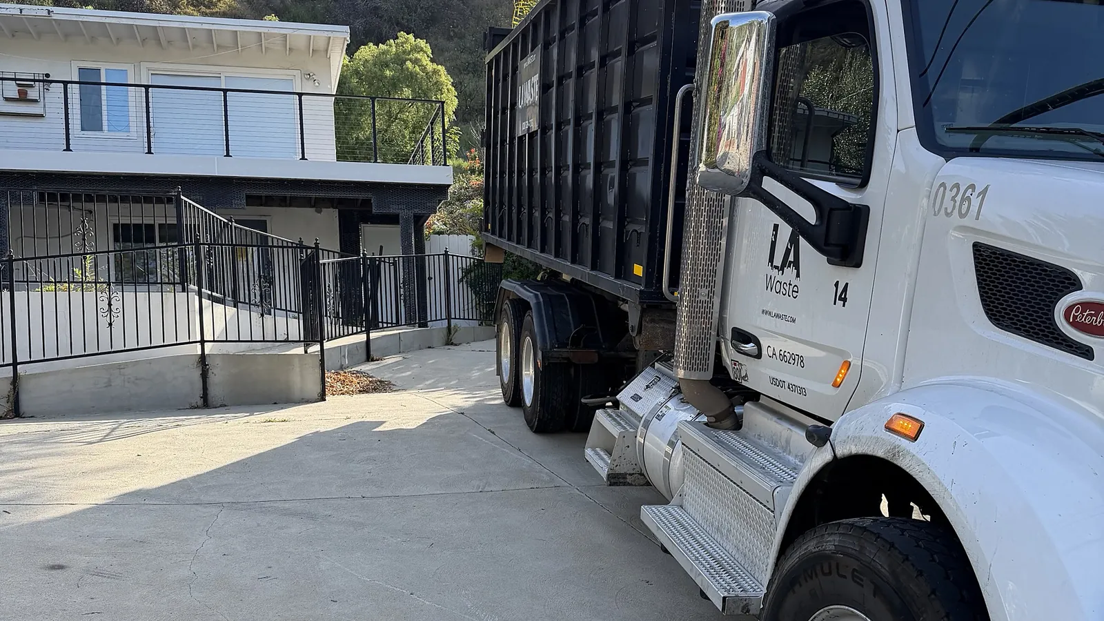 LA Waste roll off truck delivering to a hillside home