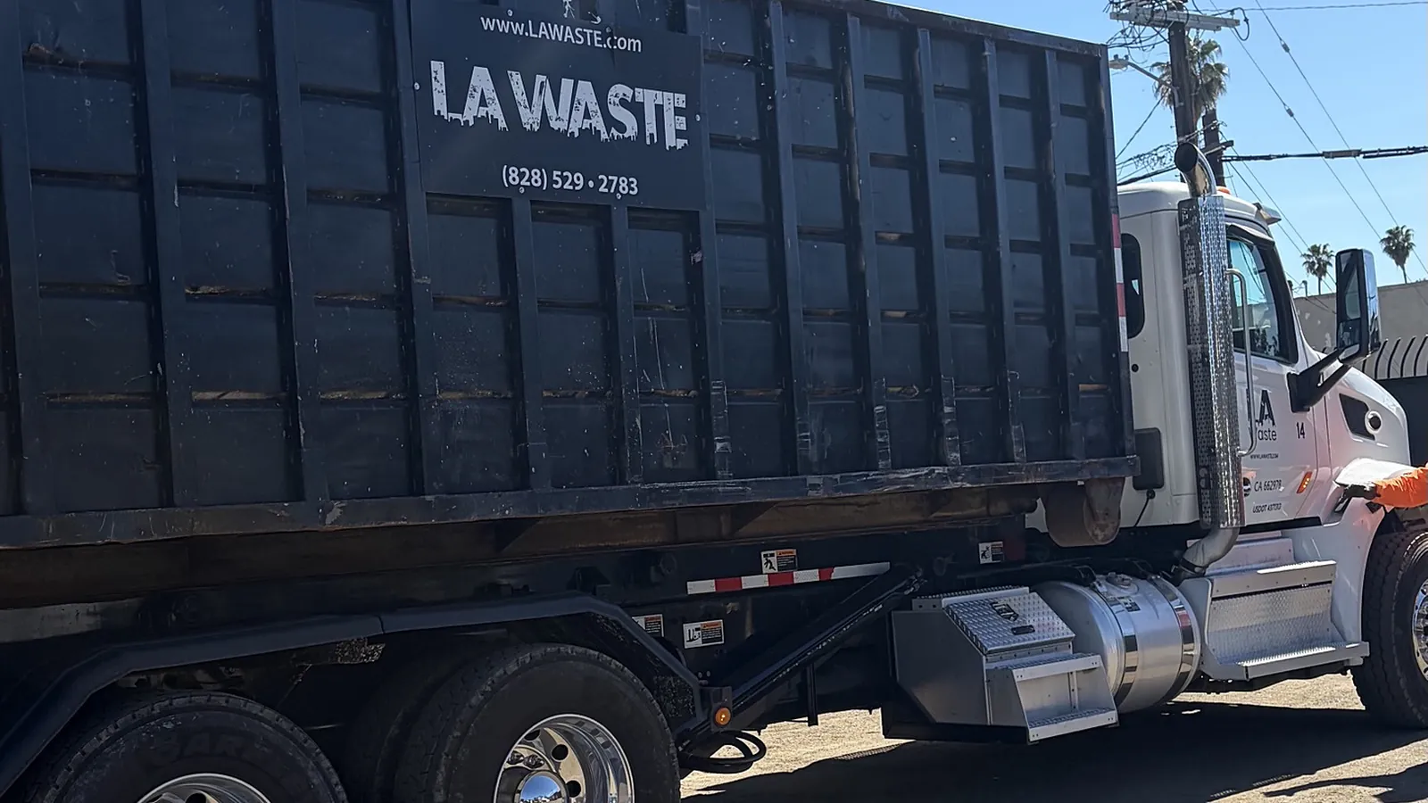 LA Waste roll off truck hauling a 40 yard dumpster
